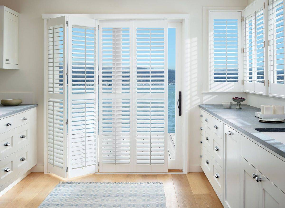 White coastal kitchen outfitted with bright white Hunter Douglas Palm Beach™ Polysatin™ Shutters near Boynton Beach, FL