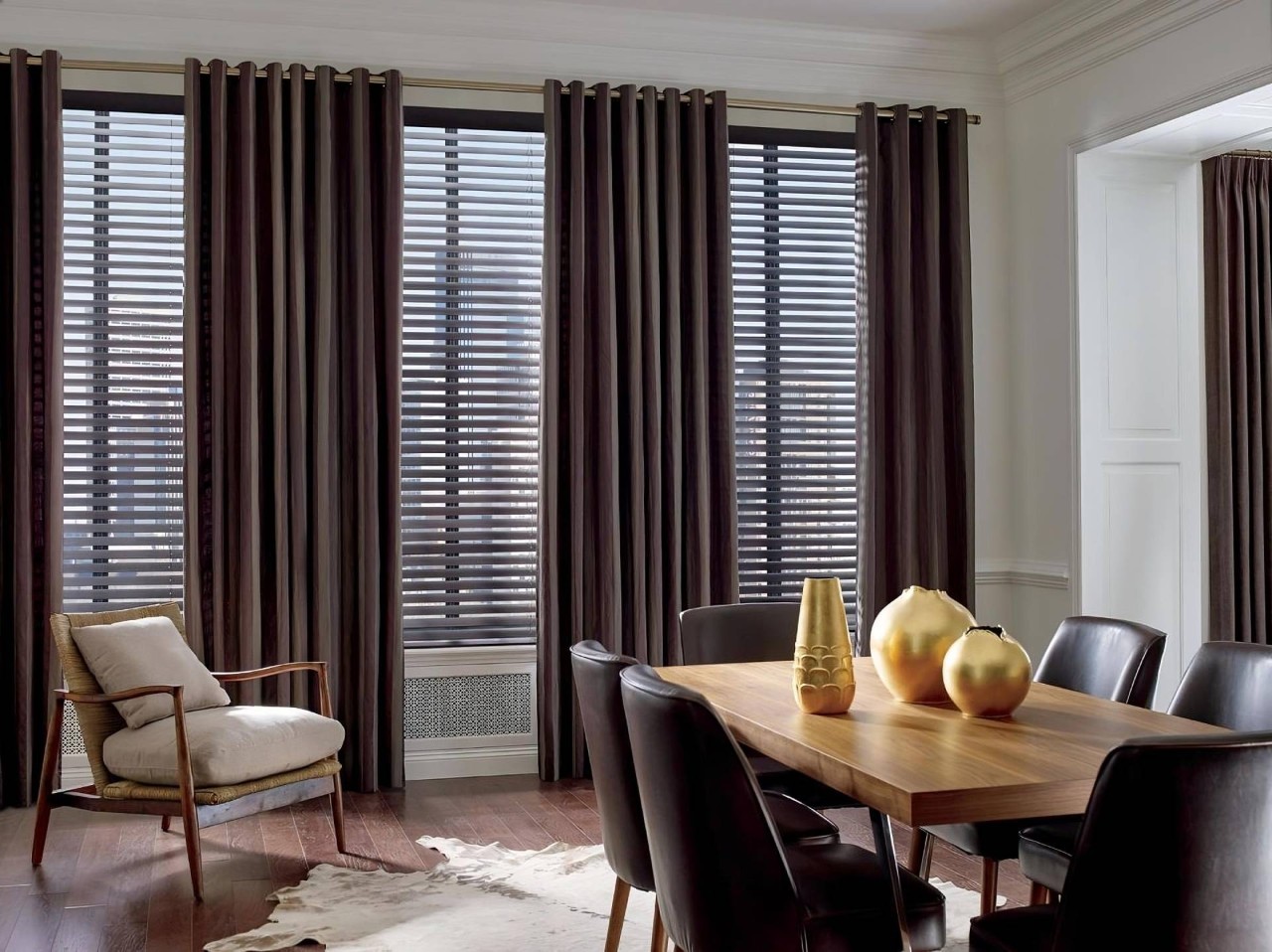 Apartment with large windows covered by Hunter Douglas metal blinds and dark-colored drapes near Boynton Beach, FL