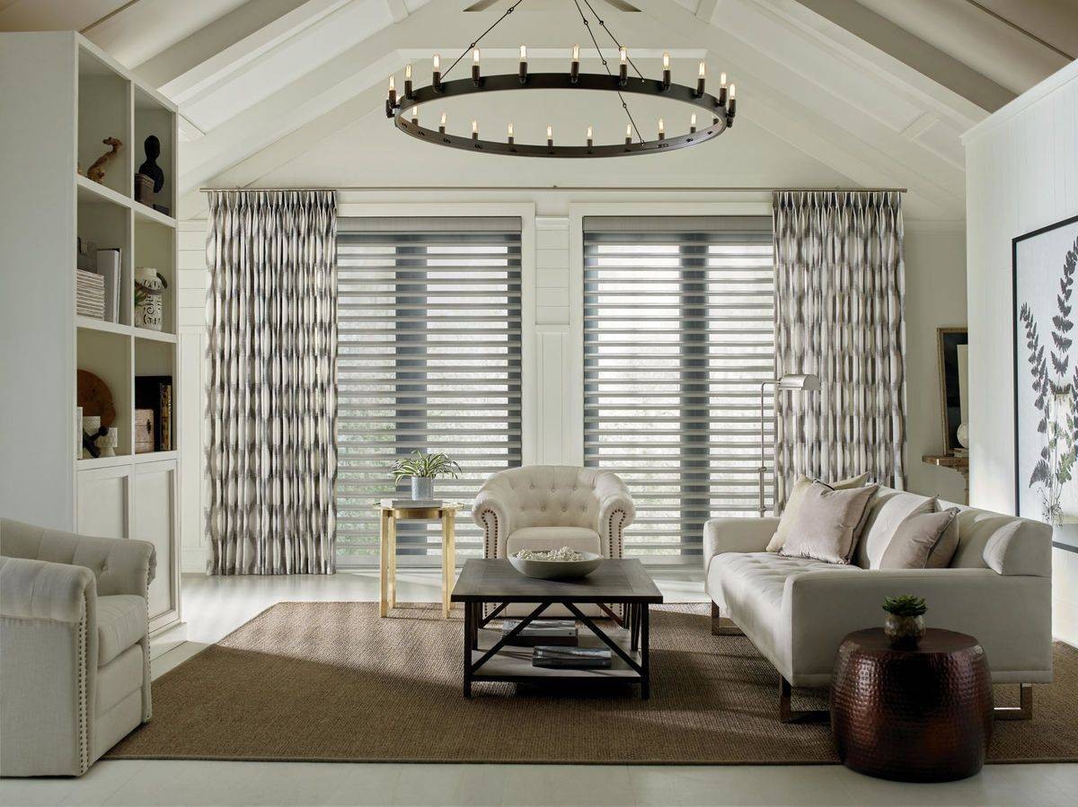 Patterned Hunter Douglas drapes paired with Hunter Douglas shutters near Boynton Beach, FL